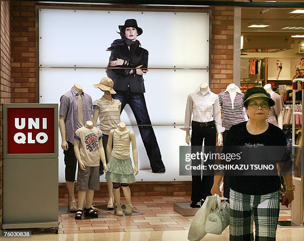 Customer leaves a Uniqlo casual wear shop, operated by Japanese apparel giant Fast Retailing in Tokyo, 09 August 2007. Fast Retailing said the...