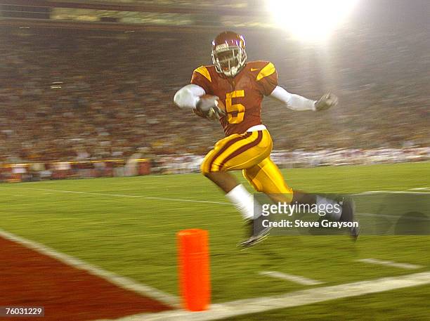 Reggie Bush of USC heads for the endzone on 42 yard touchdown run against the Stanford Cardinal in the first-half of their contest at the Los Angeles...