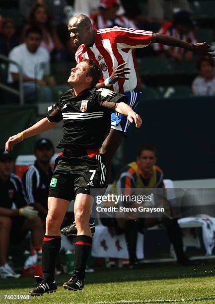 Ezra Hendrickson of CD Chivas in action against Steve Guppy of D.C. United during their contest at the Home Depot Center in Carson, California April...