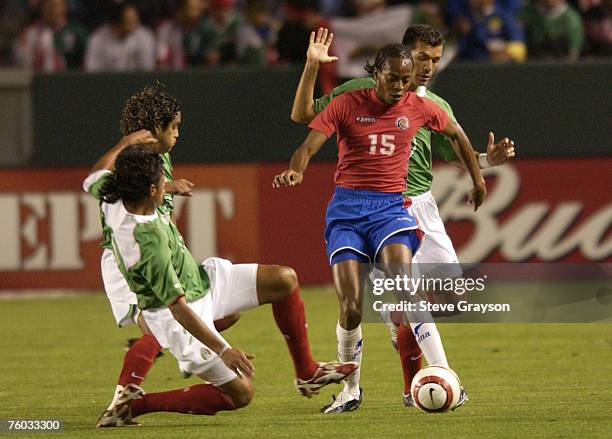Junior Diaz of Costa Rica tries to control the ball despite pressure from a trio of defenders.