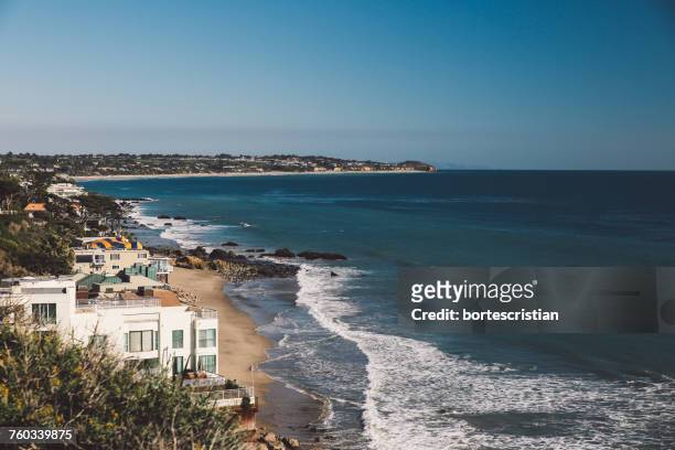 scenic view of sea against clear blue sky - malibu stock pictures, royalty-free photos & images