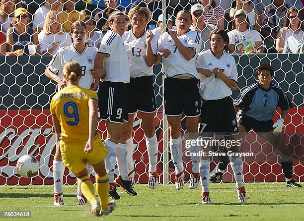 Malin Andersson of Sweden in attempts a free kick pass through a wall of German defenders in the first half.