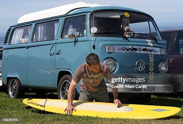 Mark Clarke waxs his surfboards above Watergate Bay close to the site of the Ripcurl Boardmasters at Fistral Beach on August 9 2007 in Newquay,...