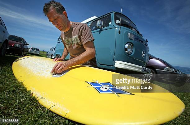 Mark Clarke waxes his surfboard above Watergate Bay close to the site of the Ripcurl Boardmasters at Fistral Beach on August 9, 2007 in Newquay,...