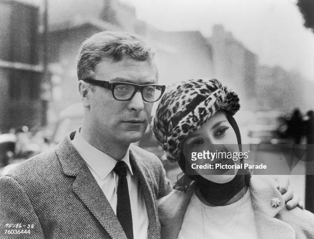 British actor Michael Caine poses with his co-star Sue Lloyd during a break in the location filming of 'The Ipcress File' in London, 1965.