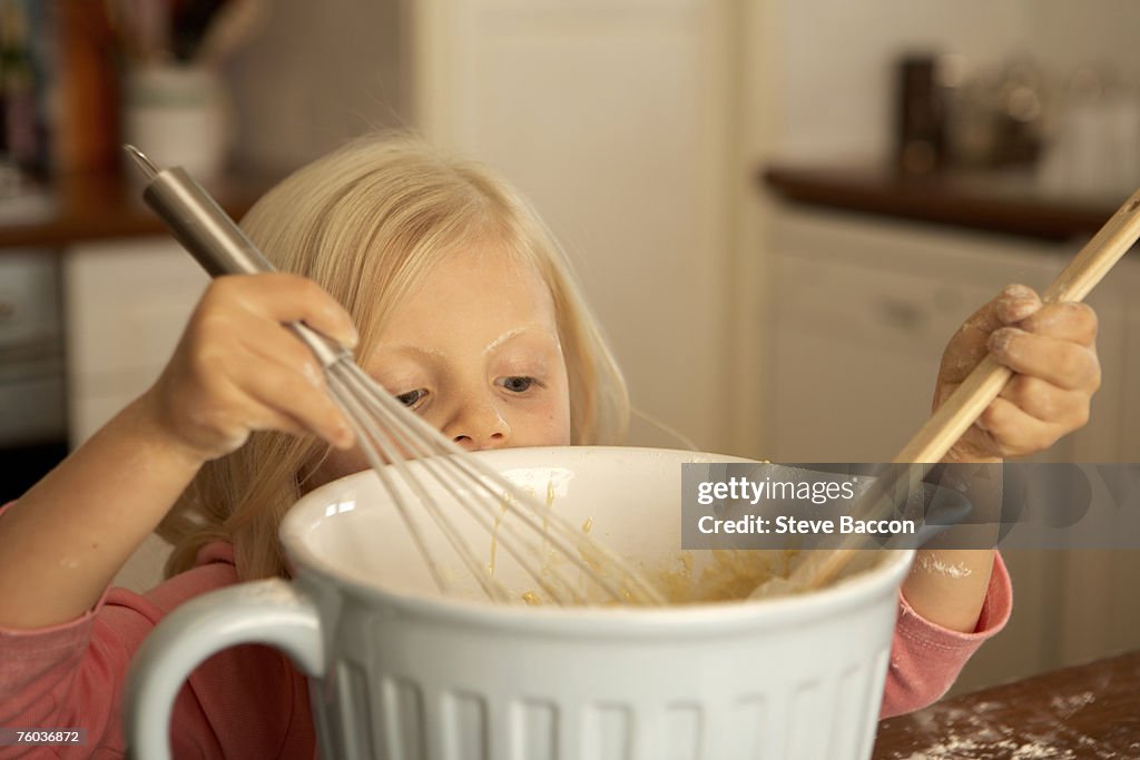 Girl (4-5) baking in kitchen, close-up