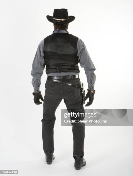 mature cowboy, against white background, rear view - sheriff stock-fotos und bilder