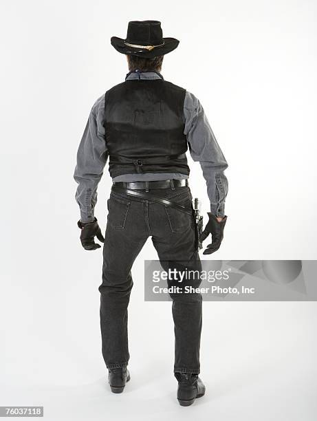 mature cowboy, against white background, rear view - 保安官 ストックフォトと画像