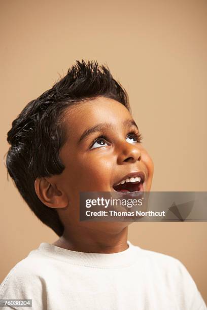 boy (4-5) smiling, looking up, studio shot - child portrait studio stock pictures, royalty-free photos & images