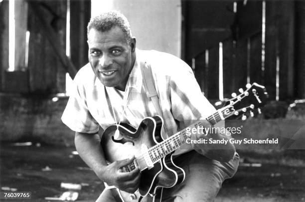 Blues musician Howlin' Wolf poses for a portrait session holding an Epiphone hollowbody electric guitar behind the Fillmore in July 1968 in San...