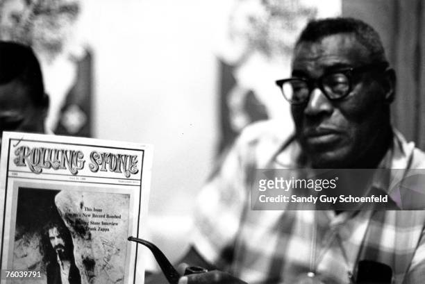 Blues musician Howlin' Wolf poses for a portrait in a hotel room holding a copy of Rolling Stone magazine with Frank Zappa on the cover in July 1968...