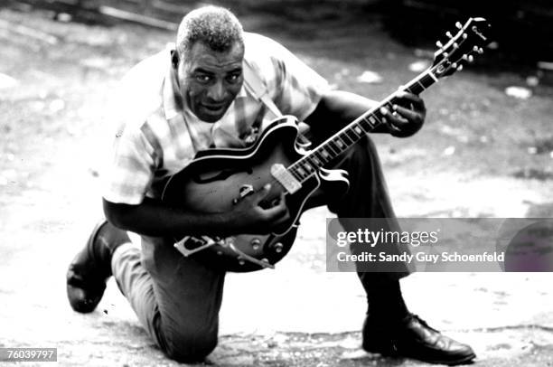 Blues musician Howlin' Wolf poses for a portrait session holding an Epiphone hollowbody electric guitar behind the Fillmore in July 1968 in San...