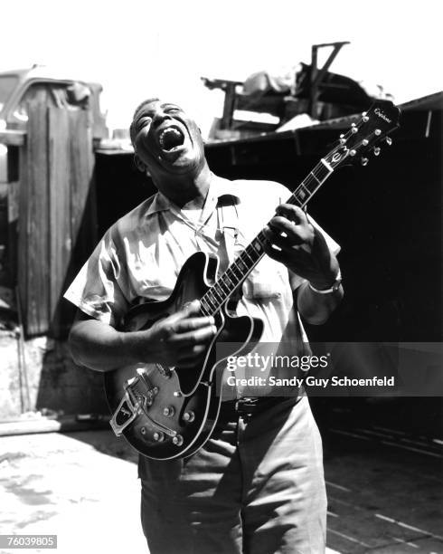 Blues musician Howlin' Wolf poses for a portrait session holding an Epiphone hollowbody electric guitar behind the Fillmore in July 1968 in San...