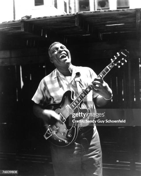 Blues musician Howlin' Wolf poses for a portrait session holding an Epiphone hollowbody electric guitar behind the Fillmore in July 1968 in San...