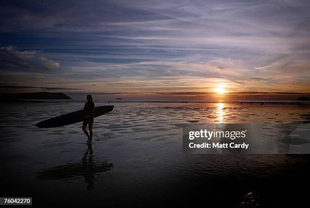 Surfer walks from the sea at Polzeath near to site of the Ripcurl Boardmasters at Fistral Beach on August 9, 2007 in Cornwall, England. The annual...