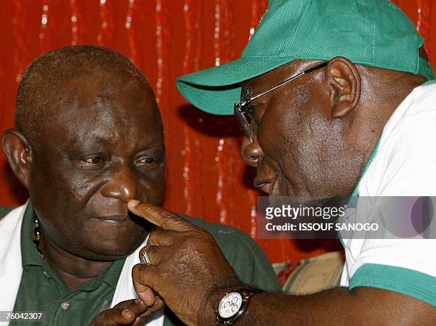 Sierra Leone's outgoing President Ahmad Tejan Kabbah talks with current vice president Solomon Berewa during an election campaign rally in Freetown...