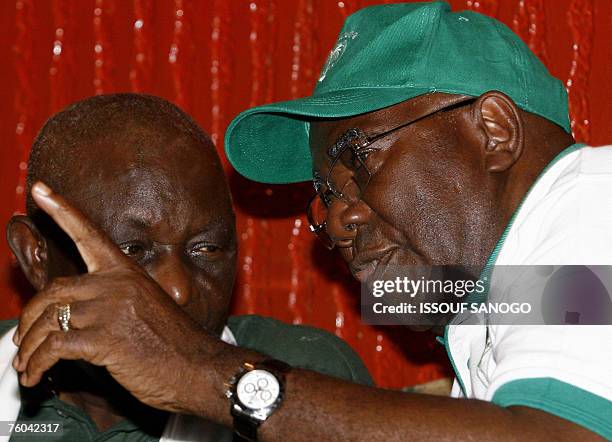 Sierra Leone's outgoing President Ahmad Tejan Kabbah talks with current vice president Solomon Berewa during an election campaign rally in Freetown...