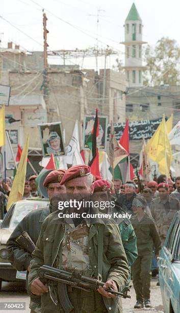 Palestinians march through the Palestinian refugee camp Ain El Helweh March 29, 2002 near Sidon, Lebanon. The demonstration was in reaction to the...