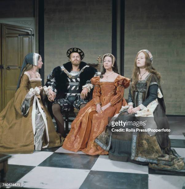 Australian actor Keith Michell pictured dressed in period costume as King Henry VIII with three of his six wives during production of the BBC TV...