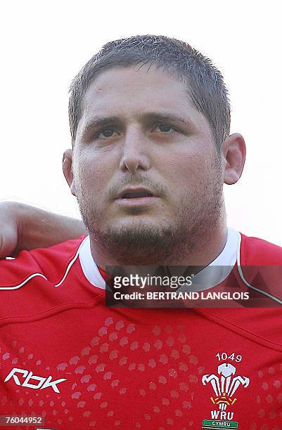 Welsh rugby union prop Rhys Thomas listens to the national anthems as he prepares to play against England in a Test match at Twickenham in west...