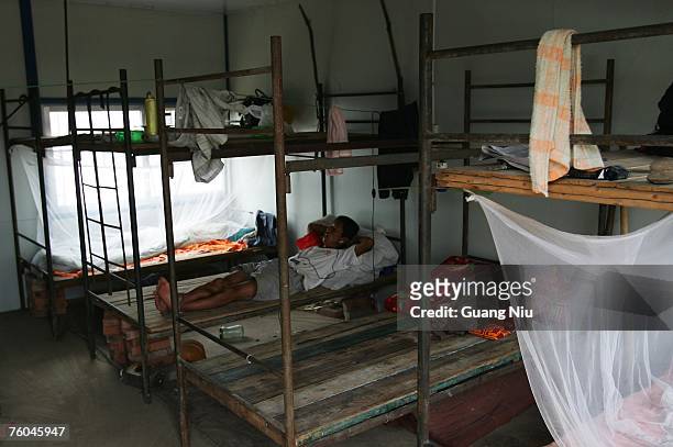 Migrant worker sleeps in a dormitory at a construction site of the National Stadium on August 10, 2007 in Beijing, China. Beijing Olympic organisers...