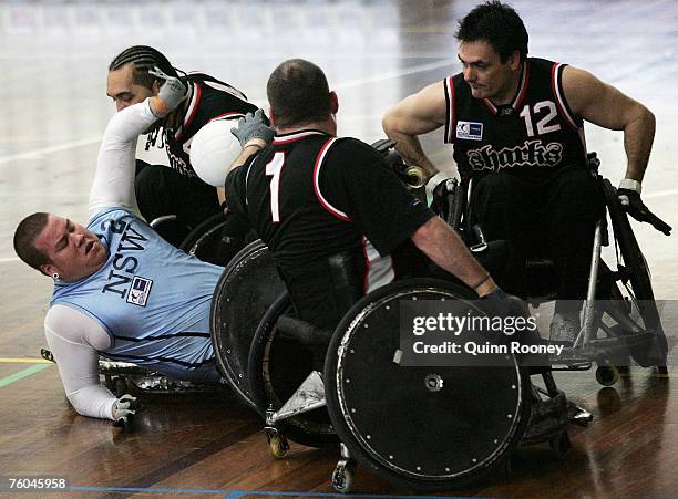 Players contest the ball during the round two National Wheelchair Rugby League match between the New South Wales Gladiators and the South Australia...