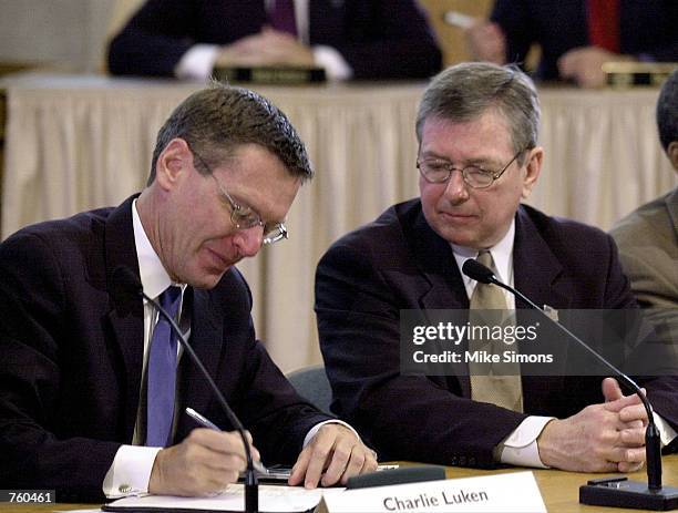Attorney General John Ashcroft looks on as Cincinnati Mayor Charlie Luken signs a landmark agreement April 12, 2002 in the Cincinnati, OH City...