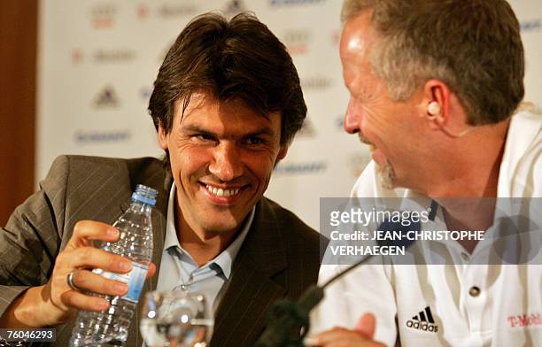 Mobile General Manager Bob Stapleton and -Mobile communication officer Christian Frommert smile as they drink water during a press conference 09...