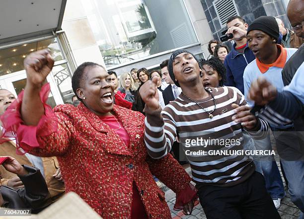 South African axed Health deputy minister Nozizwe Madlala-Routledge sings and dances, 10 August 2007, with TAC activists after giving a press...