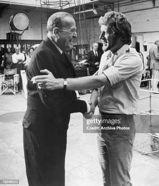Director Peter Collinson welcomes his godfather, actor Noel Coward onto the set of Paramount Pictures' 'The Italian Job' during filming in Ireland,...