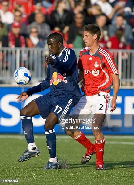 New York Red Bulls forward Josmer Altidore fends off defender Andrew Boyens during the match against the Toronto FC in Toronto, Ontario, Canada on...