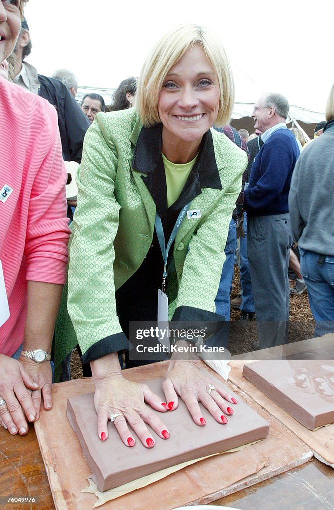 Camp founder Pattie Petty poses while making her hand prints in clay ...