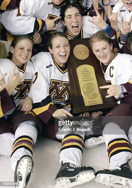 Minnesota's Krissy Wendell, center, Kelly Stephens, right, Noelle Sutton, top, Chelsey Brodt, left, pose for the camera after winning the...