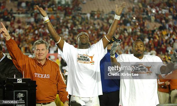 Texas coach Mack Brown, Vince Young and Michael Huff celebrate 41-38 victory over USC in the BCS National Championship game at the Rose Bowl in...