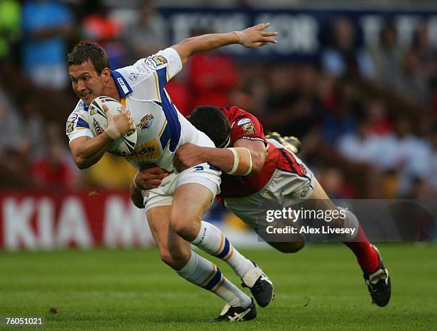 Danny McGuire of Leeds Rhinos is tackled by Michael Korkidas of Salford Reds during the Engage Super League match between Leeds Rhinos and Salford...