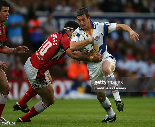Danny McGuire of Leeds Rhinos is tackled by Michael Korkidas of Salford Reds during the Engage Super League match between Leeds Rhinos and Salford...
