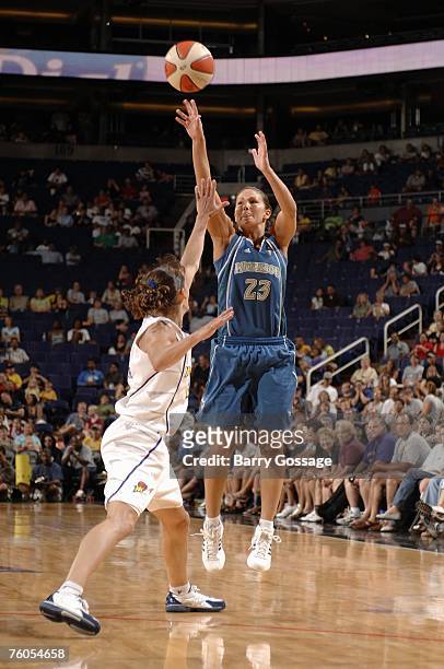 Amber Jacobs of the Minnesota Lynx shoots a jump shot over Kelly Miller of the Phoenix Mercury during a WNBA game at U.S. Airways Center on July 22,...
