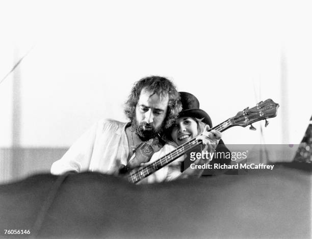 Singer Stevie Nicks and bass player John McVie of the rock group "Fleetwood Mac" perform onstage in May 1977 in Oakland, California.