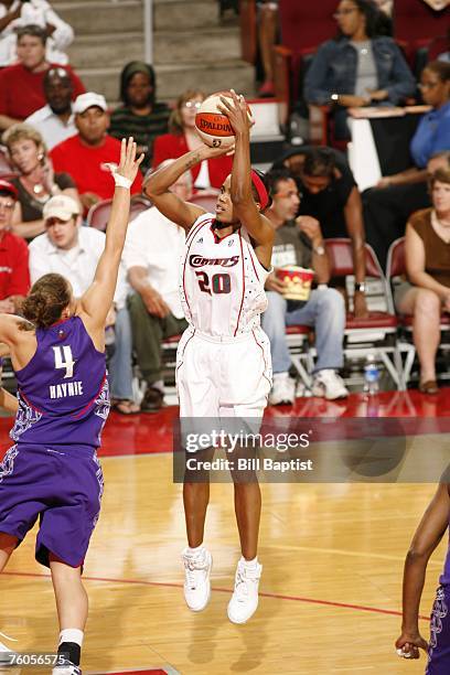 Tamecka Dixon of the Houston Comets shoots the ball over Erin Grant of the Sacramento Monarchs at the Toyota Center August 10, 2007 in Houston,...