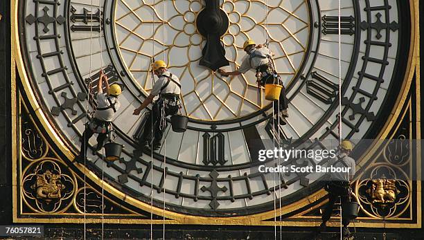 Technicians abseil down the clock face of Big Ben as they begin maintenance and cleaning work to the Westminster clock on August 11, 2007 in London,...