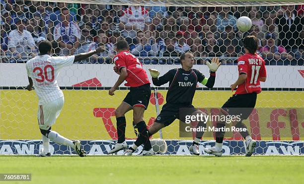 Collin Benjamin of Hamburg scores the first goal for his team during the Bundesliga match between Hanover 96 and Hamburger SV at the AWD Arena on...