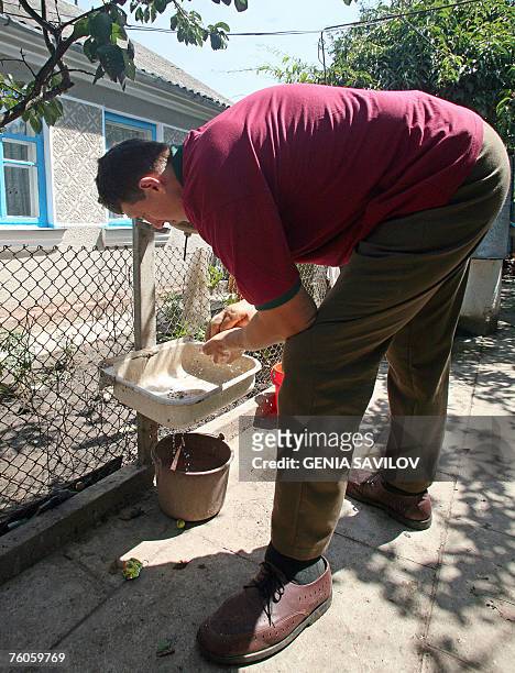 Leonid Stadnyk washes his hands at his house in Podoliantsi village, 180 km from Kiev, 11 August 2007. Leonid Stadnyk, a giant veterinary surgeon...