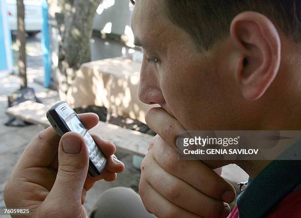 Leonid Stadnyk uses a mobile phone at his house in Podoliantsi village, 180 km from Kiev, 11 August 2007. Leonid Stadnyk a giant veterinary surgeon...