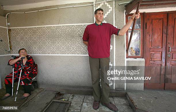 Leonid Stadnyk stands near his mother Galyna at his house in Podoliantsi village, 180 km from Kiev, Saturday, August 11, 2007. Stadnyk, a giant...