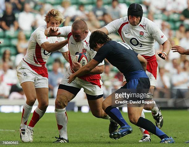 Phil Vickery of England drives forward tackled by David Skrela of France during the Investec Challenge rugby union match between England and France...