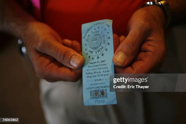 Volunteer holds a ticket used in the voting area of the Republican Straw Poll August 11, 2007 in Ames, Iowa. An estimated 40,000 people are expected...