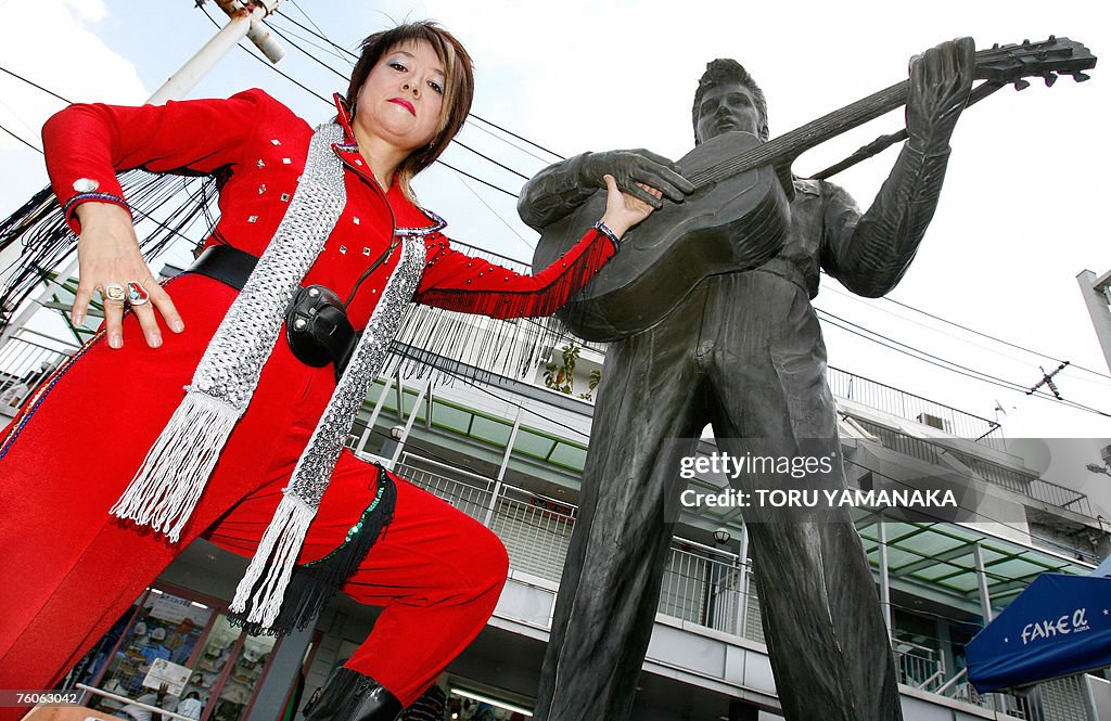 Kazue Osawa clad in her red jumpsuit pos