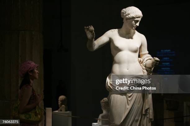 Visitor views a sculpture of Aphrodite during an exhibition of ancient Greek art from the Louvre Museum on August 11, 2007 in Beijing, China. The...
