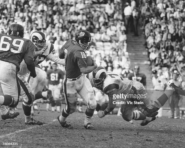 Los Angeles Rams Hall of Fame defensive end Deacon Jones dives for New York Giants quarterback Gary Lane during a 24-21 Rams victory on November 24...