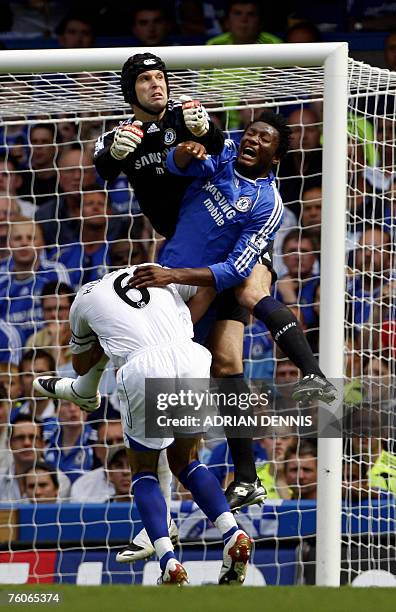 Chelsea's goalkeeper Petr Cech comes out to clear the ball challenging his teammate John Obi Mikel and Birmingham City's Captain Liam Ridgewell...